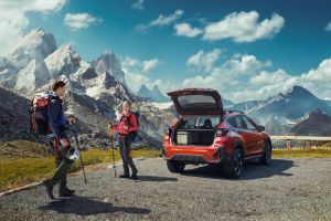 Car at the mountains with people in hiking gear